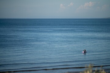 sandy beach with familys swimming at dusk on phillip island australia on a hot summer evening