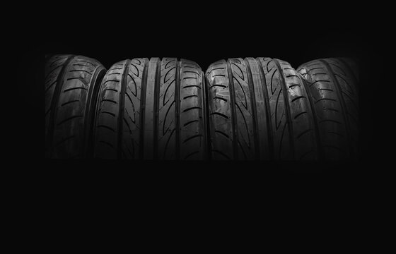 Car tires on black background for copy space	