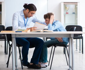 Young father helping his son to prepare for exam