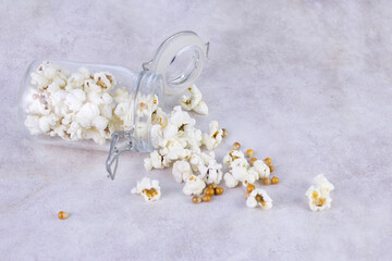 popcorn in glass jars, gray background, selective focus
