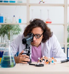 Funny male chemist working in the lab