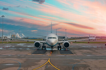 Fototapeta na wymiar Passenger planes parked in the air harbor during dawn sky.