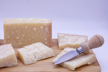 Italian Parmigiano Reggiano cheese isolated on white background. Parmesan cheese. Cose-up