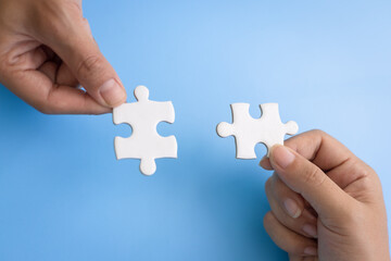  Hand of woman connecting jigsaw puzzle, Business solutions, success and strategy, Business partnership concept.
