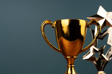 Close up of gold trophy on green background