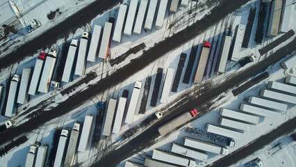 Parking lot with trucks. Winter weather. Aerial.
