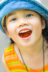 A cute little Asian girl in orange dress