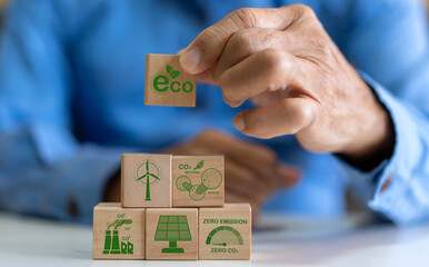 Hand holding wood block global saving clean energy earth, save the world, environment, green, eco friendly, net zero, ESG, ecology, CO2, carbon dioxide, carbon footprint.campaign save earth, earth Day