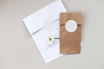 Round sticker mockup on gift white and kraft package, envelope with blank sticker, adhesive label