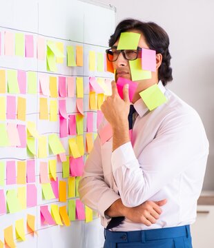 Young employee in conflicting priorities concept