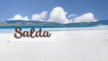 Lake Salda signage by the lake, captivating the tourists with its clear turquoise waters.
