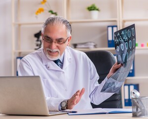 Aged male doctor radiologist in the clinic