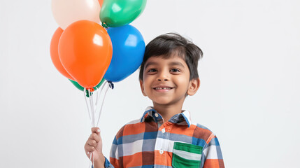 Fototapeta na wymiar cute Indian kid holding tricolor balloons against a white background,