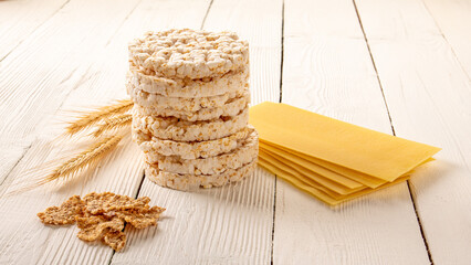 Delicious and healthy breakfast spread of rice cakes on white wooden table