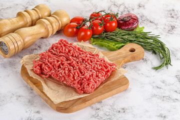 Raw minced beef meat on cutting board