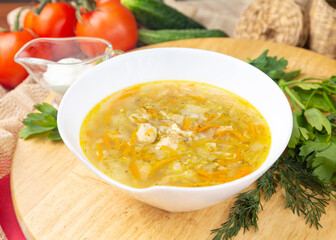 Chicken soup with carrots and noodles in a bowl. Dinner