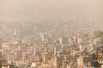 View of Kathmandu capital of Nepal from mountain through urban haze with lot of low rise buildings