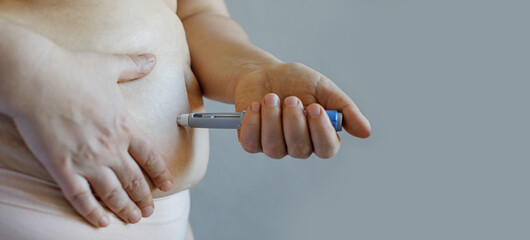 Semaglutide injection pen or insulin cartridge pen in woman hand. Diabetics and weight loss...