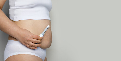 Curves female body closeup with Semaglutide Injection pen or insulin cartridge pen. Medical...