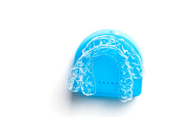 Invisible orthodontics cosmetic brackets on white background, tooth aligners, plastic braces. Modern teeth retainers created on a 3d printer. A way to have a beautiful smile and white teeth