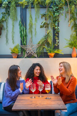 Women celebrating while drinking wine in a restaurant