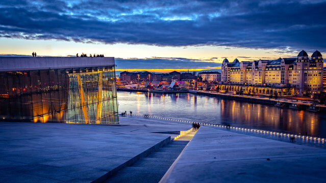Oslo, Norway - Dec 26, 2019: Oslo harbour lookout at sunset as seen from the Opera House rooftop