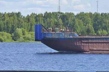 The bow of a huge floating ship with a rusty hull. Tanker or tugboat. As a child, a ship sails...
