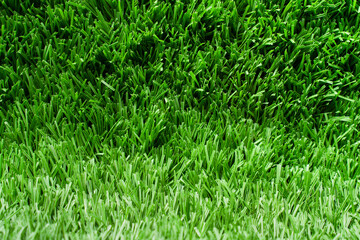 Close up of vibrant green artificial grass turf in residential.