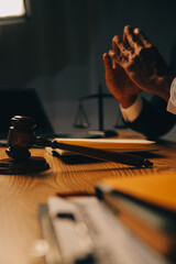 Judge gavel with Justice lawyers having team meeting at law firm background. Concepts of Law and Legal services.