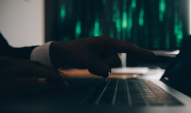 Hacker code in laptop. Cyber security, privacy or hack threat. Coder or programmer writing virus software, malware, internet attack or developing digital design. Green web data in computer screen.