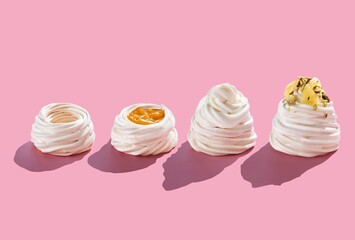 Pavlova cakes 4 stages of preparation. on a pink background with hard shadows