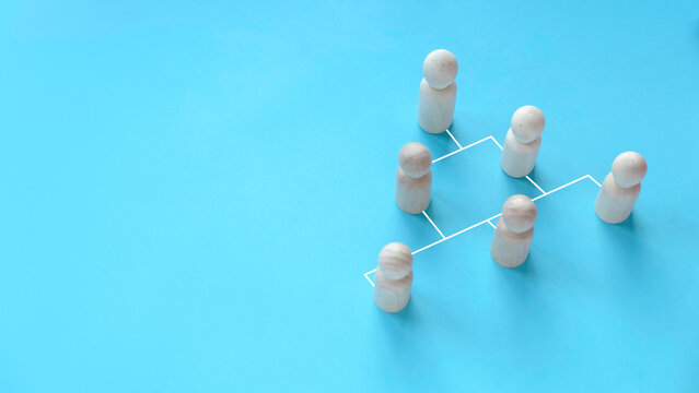 Company hierarchical organizational chart of blocks on blue background with copy space.
