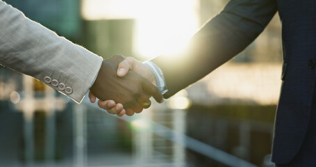 Business people, shaking hands and city meeting for b2b partnership, outdoor deal and travel...