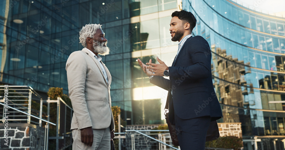 Wall mural Business men, friends and walk in street, check watch and ready for meeting, schedule or happy in city. Partnership, time management and direction to workplace with discussion, road or metro sidewalk