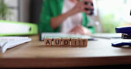 Woman at desk puts stamp on documents text audit. Company auditing services