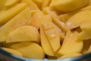 Raw potatoes in spices and salt. Preparation of ingredients.Cooking healthy food
