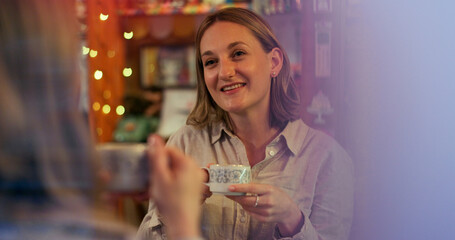 Women, friends and talk in coffee shop, drink and happy for reunion, date and conversation on break. Girl, people and smile for chat, memory and relax with tea cup, latte or espresso in cafe together