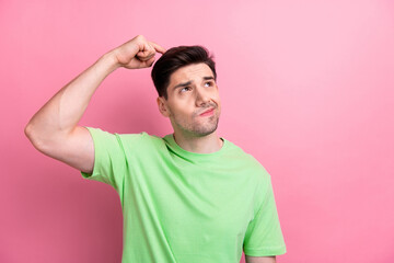 Photo of young funny man failed thinking and scratching head confused looks empty space solving...