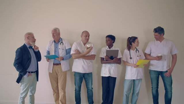 group of doctors in medical center talking together in rest or meeting room
