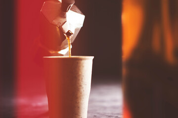 Pouring coffee with a moka pot in ceramic mug
