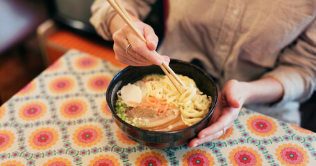Ramen food, plate and table in restaurant with person, hands and ginger with closeup for Japanese...