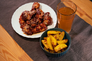  BBQ wings with crispy fried potatoes and beer. Fatty and junk food from the bar