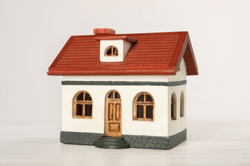 Mortgage concept. House model on white wooden table