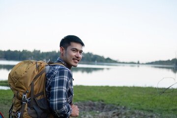 Asian tourist smiling happily Backpacker, hiking trips, outdoor activities on vacation.