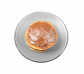 Delicious pancakes with chocolate paste isolated on white, top view