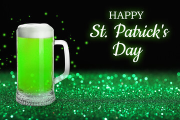 Happy St. Patrick's Day. Tasty green beer on shiny glitter against black background