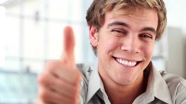 Businessman, face and thumbs up for approval or agreement in office, like emoji and satisfaction. Male person, portrait and promotion or support in review, happy and yes for feedback and good job