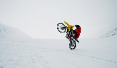 Winter motocross. Racers ride on ice. Winter sports.