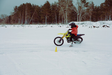 Winter motocross. Racers ride on ice. Winter sports.