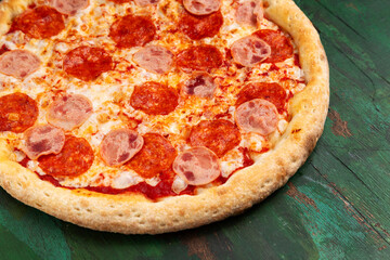 Pizza with ham and salami. Close-up.